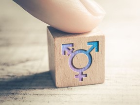 Transgender, LGBT or Intersex Icon On Wodden Block On A Table Arranged By A Finger. For Ian Mulgrew Vancouver Sun column published in September 2021. (Photo: iStock / Getty Images Plus) [PNG Merlin Archive]