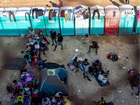 Migrants, mostly from Haiti, gather at a makeshift encampment under the International Bridge on the border between Del Rio, TX and Acuña, MX.