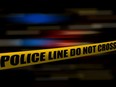 STOCK IMAGE - Yellow police line tape sign at crime scene.
