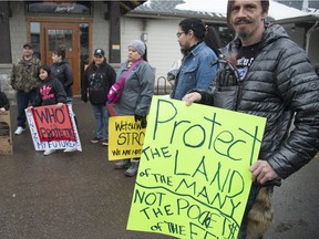 Protesters are seen outside of a meeting between Wet'suwet'en hereditary chiefs and Federal and Provincial ministers in Smithers, B.C., Friday, Feb. 28, 2020.