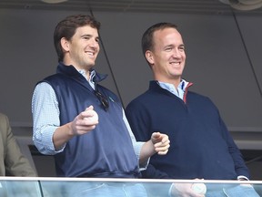 Eli (left) and Peyton Manning, pictured in 2014, have doubled their audience over the course of the first two weeks of the NFL season with their Monday Night Football game commentary on ESPN 2.