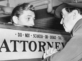 Robert Mitchum, who served 50 days in jail on a marijuana conviction, talks with attorney Jerry Geisler about his release on March 29, 1949.