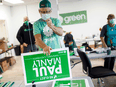 Campaign workers put together signs for Green Party candidate Paul Manly in Nanaimo, B.C. Manly lost his seat after serving just over two years as an MP.