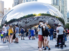 Americans congregate at at the Cloud Gate sculpture in Millennium Park in Chicago, Illinois, U.S., September 5, 2021.