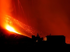 Lava and smoke rise following the eruption of a volcano on the Canary Island of La Palma, in El Paso, Spain, September 25, 2021.