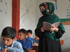 A teacher conducts a class at a government middle school in Kabul on August 30, 2021.