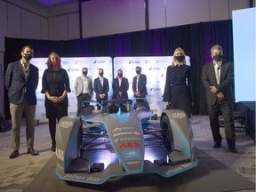 September 2021: Dignitaries and officials gather around a race car after the announcement of the Canadian E-Fest program at the Douglas Hotel in Vancouver on Sept. 29, 2021. The three-day event, set for June 30 to July 2, 2022, was to feature an esports tournament, concerts and a race featuring electric cars, until its cancellation in April 2022.