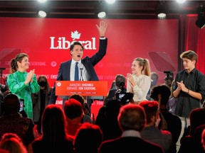 Canada's Liberal Prime Minister Justin Trudeau, accompanied by his wife Sophie Gregoire and their children Ella-Grace and Xavier, waves to supporters during the Liberal election night party in Montreal.