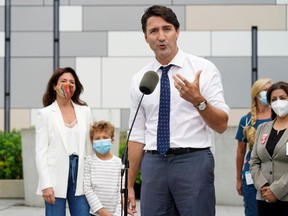 Liberal leader Justin Trudeau speaks while his wife, Sophie Gregoire Trudeau, and their son, Hadrien Trudeau, listen at an election campaign stop in Vancouver on Sept. 13, 2021.