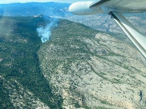 Smoke rises as wildfires continue to spread near Penticton, B.C., August 28, 2021, in this photo obtained from social media.