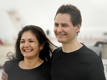 Michael Kovrig embraces his wife Vina Nadjibulla, left, after arriving at Pearson International Airport in Toronto, Saturday, Sept. 25, 2021.