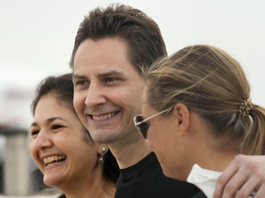 Michael Kovrig embraces his wife Vina Nadjibulla, left, after arriving at Pearson International Airport in Toronto, Saturday, Sept. 25, 2021.