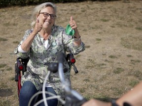 The Green candidate for Saanich-Gulf Islands, Elizabeth May, greets people from her walker on Tuesday in Saanich. May, the former party leader, recently had knee surgery.