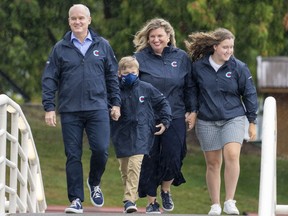Conservative Leader Erin O'Toole along with his wife Rebecca and children Jack and Mollie walk over a bridge in Nanaimo on Saturday, Sept. 4, 2021.