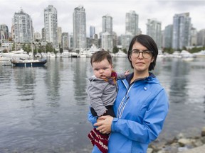 Robyn Chan and her four-month-old daughter Ramona in Vancouver on Sept. 28. Chan is a volunteer with the city planning commission and is concerned that the city is stopping virtual meetings.