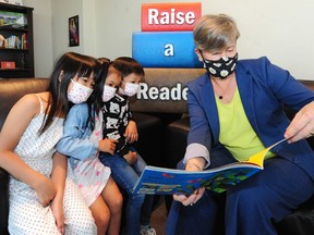 Minister of Municipal Affairs Josie Osborne with (from left to right) Aubrey Trinh, Olivia Trinh and Quinto Hsu.