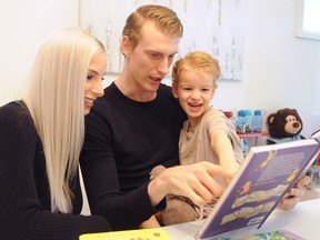 Vancouver Canuck Tyler Myers and wife, Michela, read to their son Tristan.