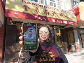 Susan Liu, co-owner of Kam Wai Dim Sum, shows that her restaurant is an official ‘PokeStop’ on the Pokemon Go game app circuit. Liu recalls one customer picking up frozen dumplings ‘was at the till, and trying to put her Pokemon into the gym, and telling her husband, ‘you pay!’ ”