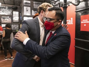 Newly elected Liberal MP for Richmond Centre Wilson Miao is congratulated by a supporter after arriving at the party headquarters in Vancouver.