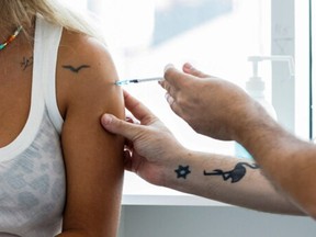 An Israeli woman receives a third shot of coronavirus disease (COVID-19) vaccine in Tel Aviv, Israel August 30, 2021.