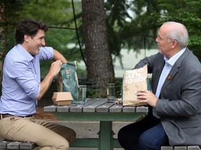 Prime Minister Justin Trudeau and B.C. Premier John Horgan meet for lunch in the courtyard at Coquitlam City Hall in Coquitlam, on Thursday, July 8, 2021.