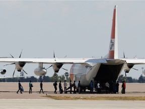Migrants board a U.S. Coast Guard airplane at the Del Rio International Airport as U.S. authorities accelerate removal of migrants at border with Mexico, in Del Rio, Texas, U.S., September 19, 2021.
