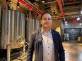 Andrew Merinoff, Great Jones Distilling Co. project manager, poses in front of whiskey vats in New York, NY.