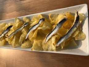 Tinned sardines – a “conserva” – served as they should be with potato chips and hot sauce at Vancouver’s Como Taperia.