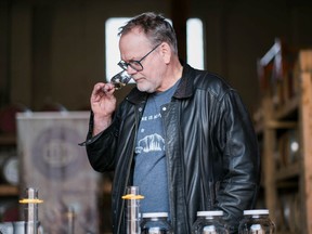 Gordon Glanz, owner and distiller at Odd Society Spirits, tests his whisky.