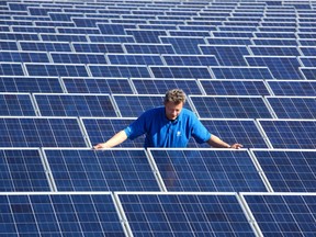 A technician checking on solar panels. ‘Green’ jobs have been held up as a new economic driver that could offset oil and gas job losses.