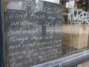 A sign in the window of Finch's Tea and Coffee House on West Pender Street in Vancouver tells people not to break their windows.