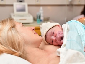 Mom and newborn baby skin to the skin after birth