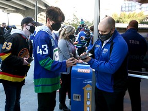 Fans are welcomed back into Rogers Arena earlier this month for a pre-season game between the Canucks and Jets.