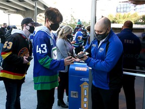 Fans are welcomed back into Rogers Arena with proof of vaccination as the Vancouver Canucks take on the Winnipeg Jets during their preseason NHL game at Rogers Arena on Oct. 3, 2021.