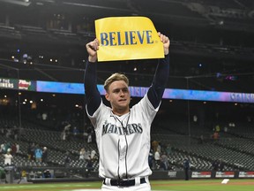 Jarred Kelenic of the Seattle Mariners holds up a "Believe" sign after the game against the Oakland Athletics at T-Mobile Park on Sept. 29, 2021 in Seattle, Washington. The Mariners won 4-2.