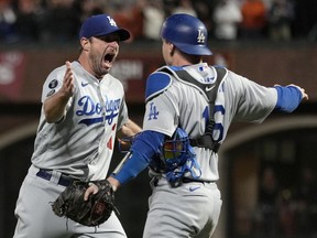 Max Scherzer and Will Smith of the Los Angeles Dodgers celebrate after beating the San Francisco Giants 2-1 in game 5 of the National League Division Series at Oracle Park on Oct. 14, 2021 in San Francisco.