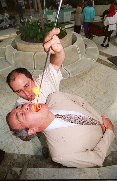Fire-eating Mayor Philip Owen shows during the StreetFare '95 Buskers launch at the Pacific Centre in Vancouver.