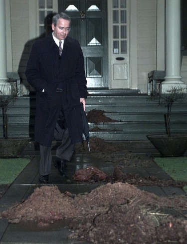Mayor Philip Owen avoids piles of manure that were dumped on his sidewalk and driveway overnight.