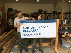 Metro Vancouver staff prepare the new sign for Belcarra Park. It is now known as t&#601;mt&#601;míx&#695;t&#601;n