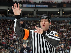 NHL Referee Steve Kozari #40 signals a call during the game between the Vancouver Canucks and the Calgary Flames during their game at General Motors Place on January 7, 2006.