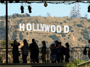 LOS ANGELES, CA - JUNE 28:  Tourists are slihouted against the distroted Hollywood sign from rising heat waves during a major heat wave in Southern California on June 28, 2013 in Los Angeles, California. Temperatures are expected to be in the triple digits in most areas of Southern California. According to the national Weather Service, the heat wave is expected to linger into early next week prompting heat advisories and opening of cooling centers.  (Photo by Kevork Djansezian/Getty Images) ORG XMIT: 171962694