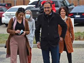 Mayoral candidate Amarjeet Sohi with his wife Sarbjeet (R) and daughter Seerat walking up to the polling station to vote at Father Michael Troy School in southeast Edmonton, October 18, 2021