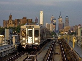 A SEPTA train on the Market-Frankford rapid transit line with the Philadelphia skyline in the background.