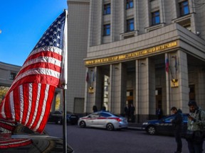 A vehicle belonging to the US embassy is stationed in front of the Russian Foreign Ministry headquarters in Moscow.
