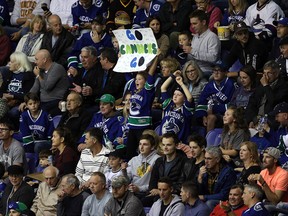 Vancouver Canucks fans cheer on their team during a preseason game against the Calgary Flames in Victoria on Sept. 16, 2019. Full capacity is once again allowed at all sporting events in B.C.