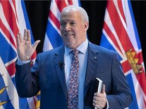 Premier John Horgan, shown here flashing the Vulcan salute, meaning "live long and prosper," during a virtual swearing in ceremony in Victoria, Thursday, Nov. 26, 2020.