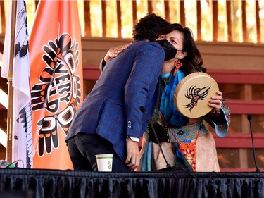 Canada's Prime Minister Justin Trudeau and Kukpi7 Rosanne Casimir embrace after exchanging gifts at the Tk'emlups PowWow Arbour in B.C., Oct. 18, 2021.