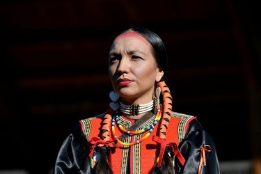 Zunika Jules, a Tk'emlups te Secweepemc band member listens to Canada's Prime Minister Justin Trudeau and Kukpi7 Rosanne Casimir speak to the press at the Tk'emlups Pow wow Arbour in B.C., Oct. 18, 2021.