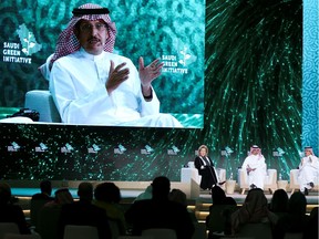 Saudi Minister of Finance Mohammed al-Jadaan, Chairman of ACWA Power International Mohammad A. Abunayyan and moderator Eithne Treanor attend the Saudi Green Initiative Forum to discuss efforts by the world's top oil exporter to tackle climate change.