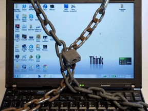 A photo illustration made December 14, 2012 in Montreal shows a computer in chains. Security experts warn about "ransomware," where computers or mobile phones are locked down by cyber thieves and money is demanded online and also cyber espionage are digital security threats in 2013.THE CANADIAN PRESS/Ryan Remiorz ORG XMIT: POS2012123114024810